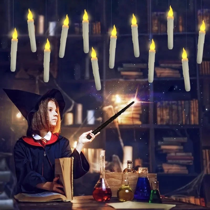 Person in a witch costume holding a wand with candles and books in the background