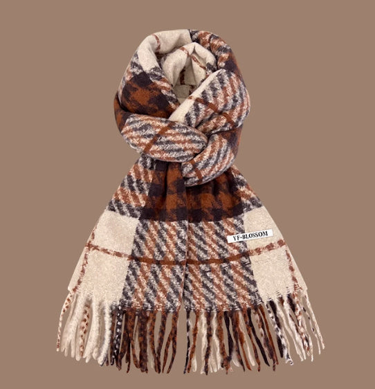 Plaid scarf with fringes on a brown background