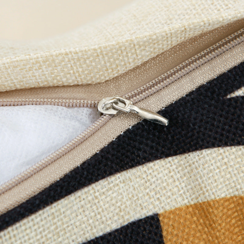 Close-up of a zipper on a fabric bag with geometric pattern