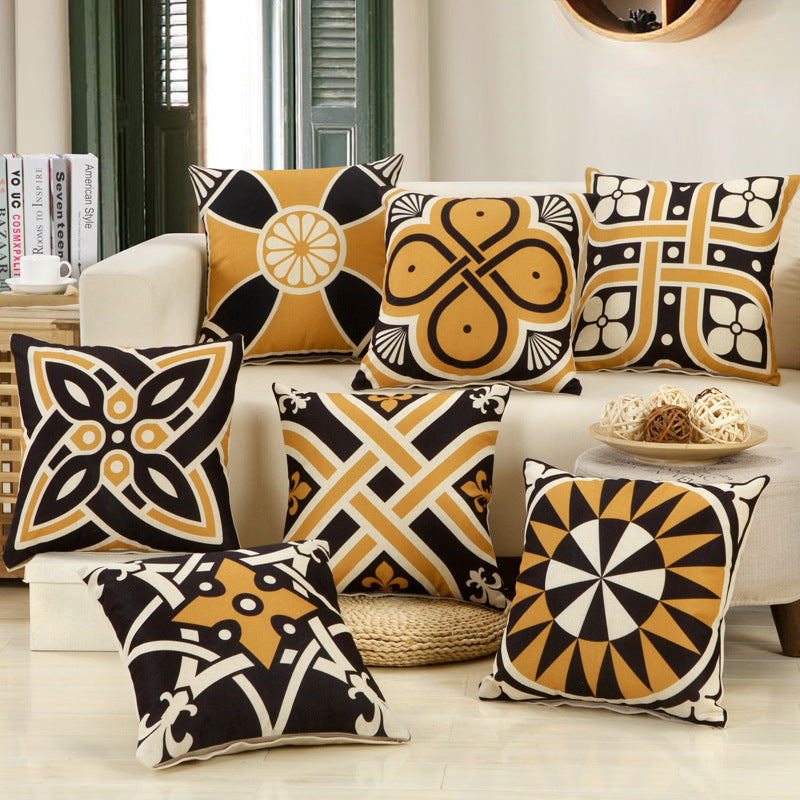 Decorative pillows with geometric patterns on a sofa in a living room setting.