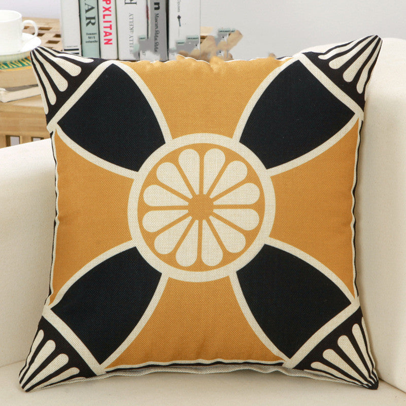 Decorative pillow with geometric pattern on a white couch