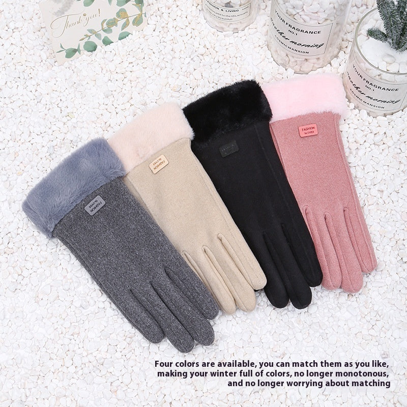 Four pairs of gloves in gray, beige, black, and pink on a white textured surface.