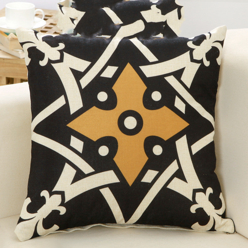 Decorative pillow with geometric pattern on a white couch