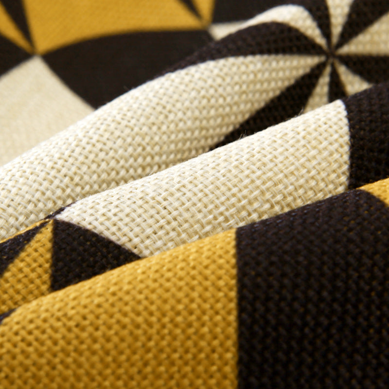 Close-up of fabric with black, yellow, and beige geometric pattern