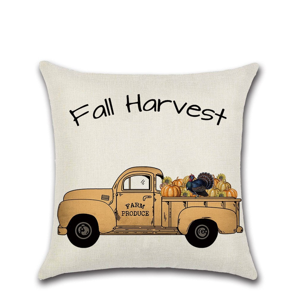 Pillow with 'Fall Harvest' text and vintage truck design on a beige background