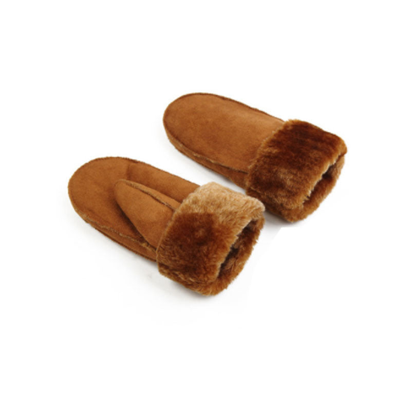 Pair of brown suede slippers with fur trim on a white background