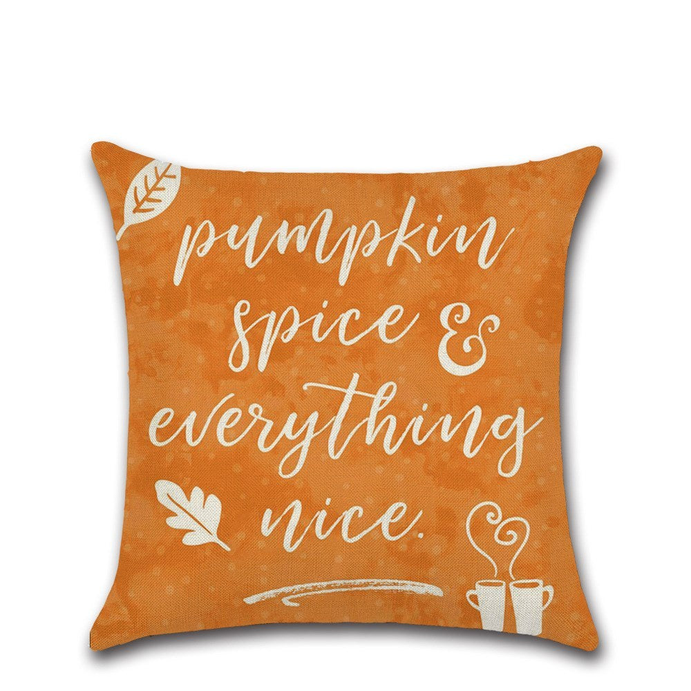 Orange pillow with 'pumpkin spice & everything nice' text on a white background
