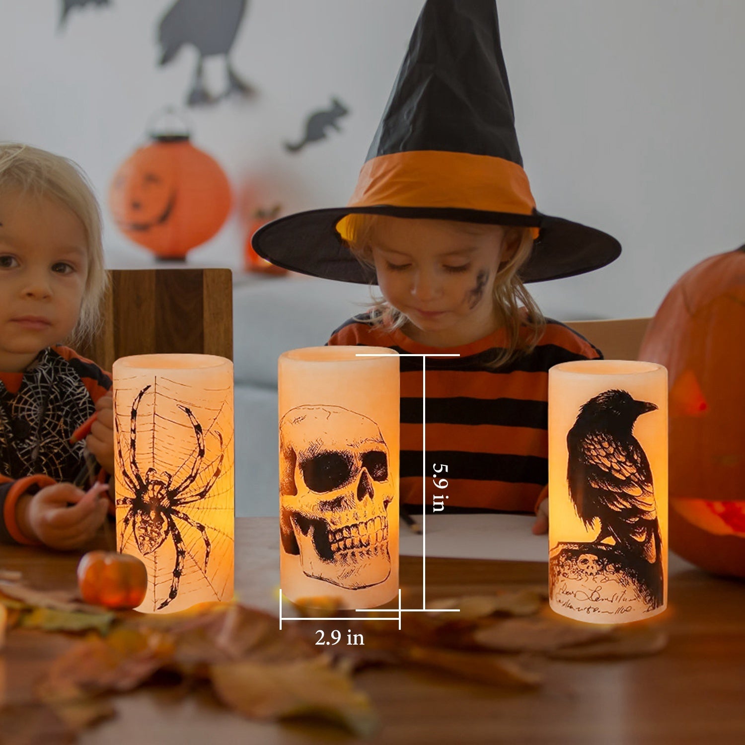 Children in Halloween costumes with lit candles featuring spider, skull, and crow designs.