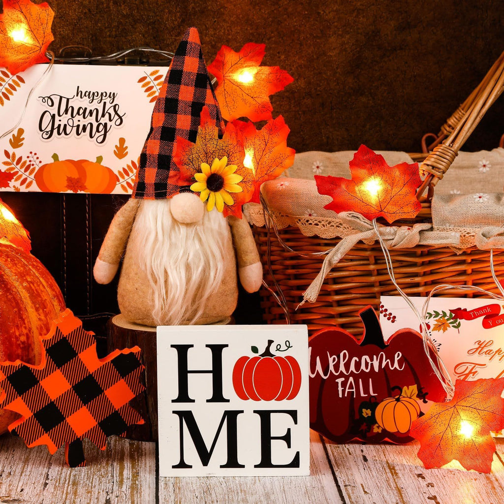 Autumn-themed decor with a gnome, pumpkins, and 'Welcome Fall' sign.