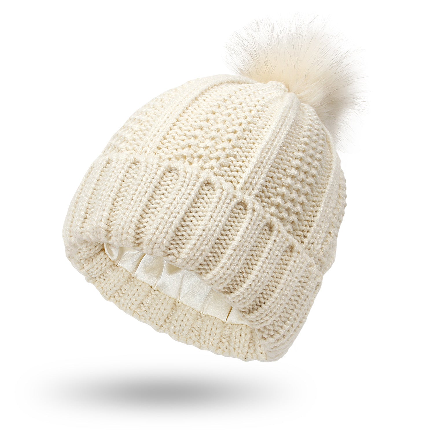 Beige knitted beanie with a pom-pom on a white background