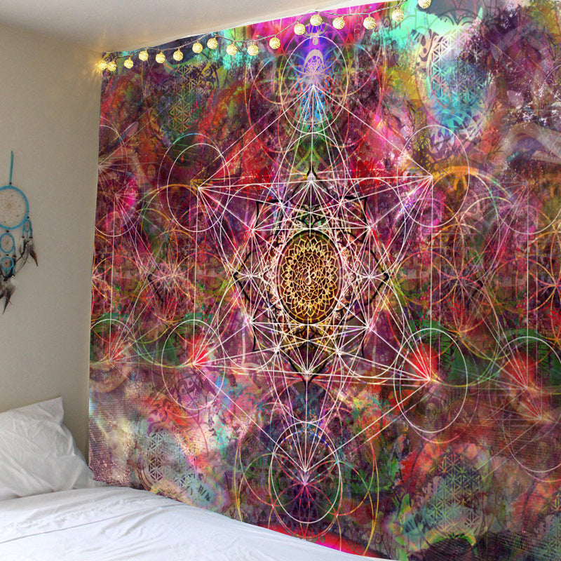 Colorful tapestry with geometric patterns hanging on a wall above a bed.