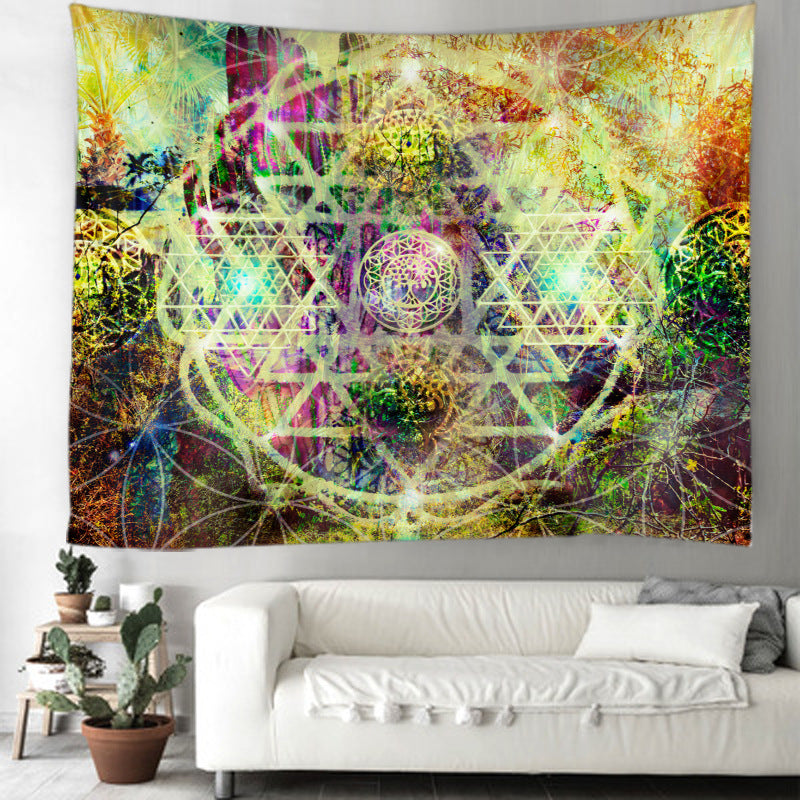 Colorful tapestry with geometric design hanging on a wall above a white sofa.