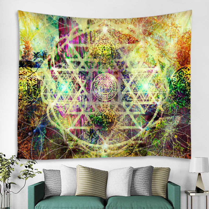 Colorful tapestry with geometric patterns hanging on a wall above a sofa.
