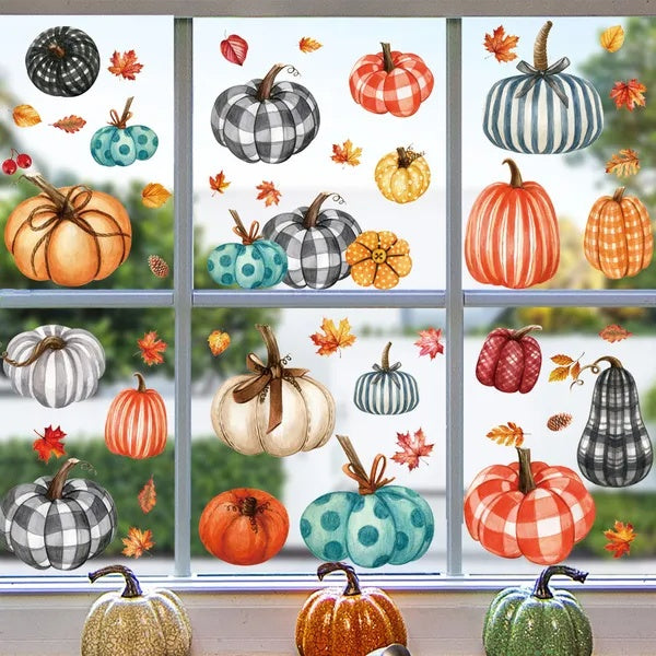 Window with colorful pumpkin and leaf decals on a clear day.