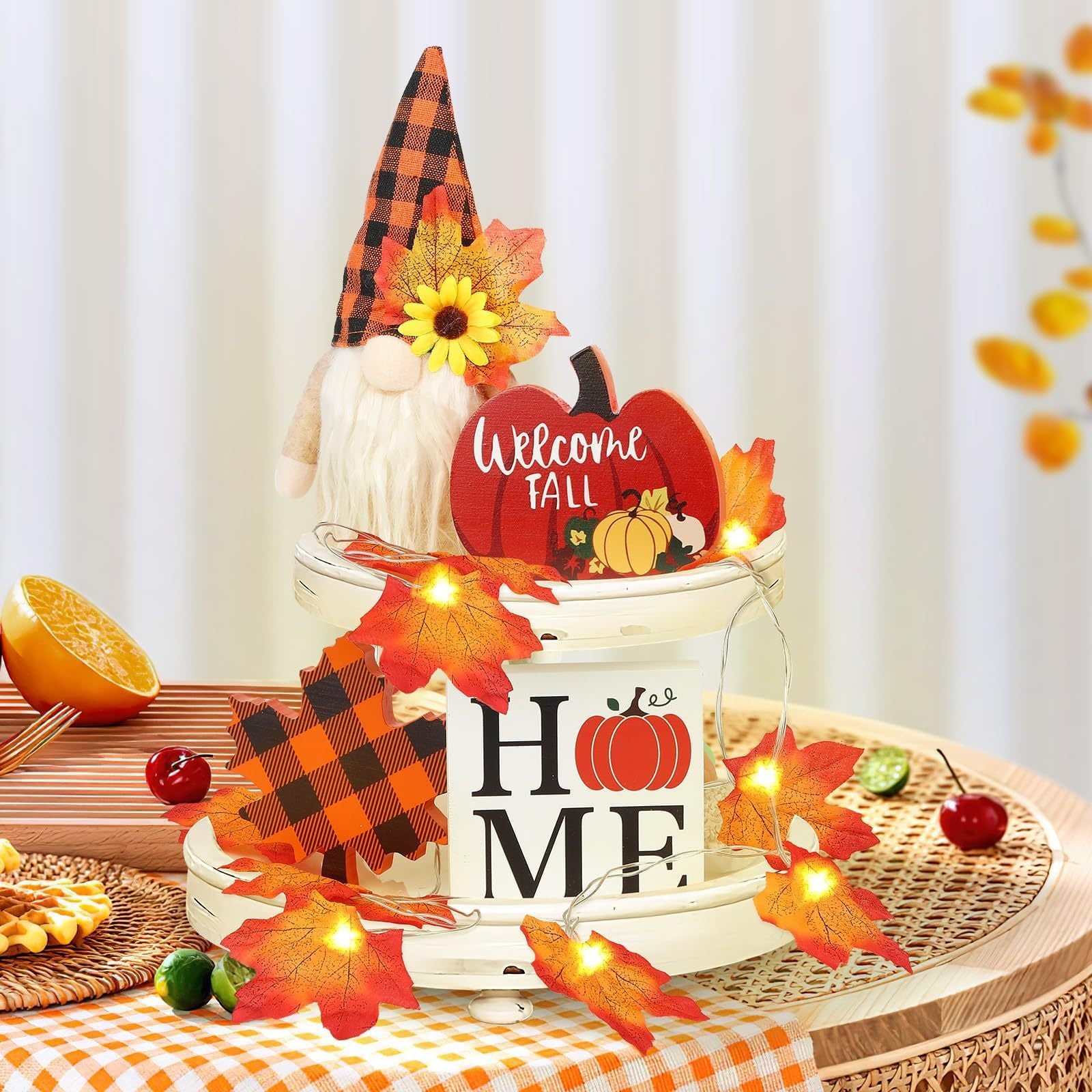 Decorative fall scene with a gnome, pumpkin, and 'Welcome Fall' sign on a table.