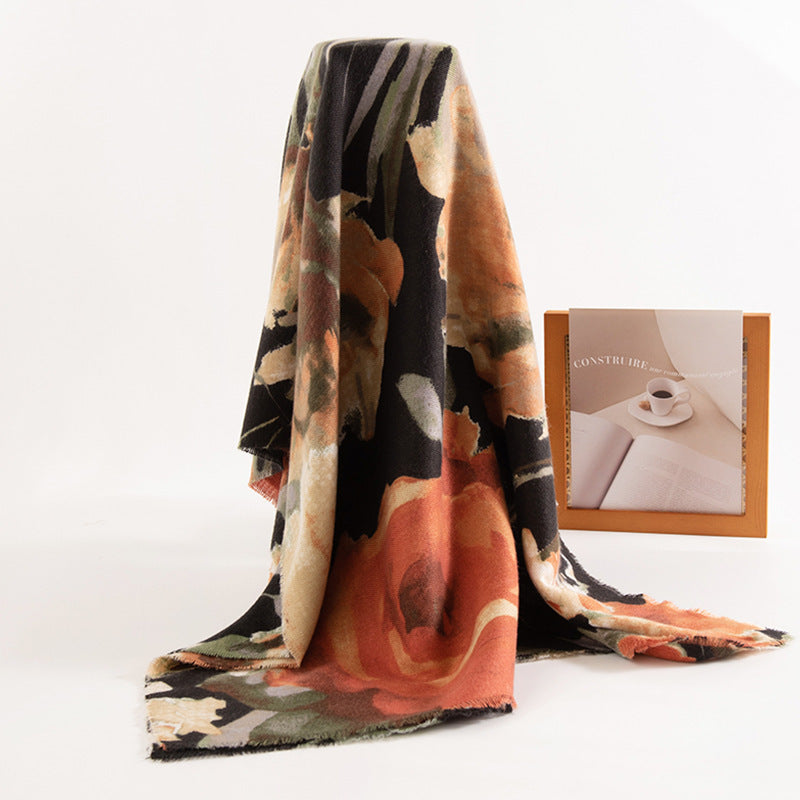 Floral patterned blanket draped over a surface with a small box featuring a coffee cup image.