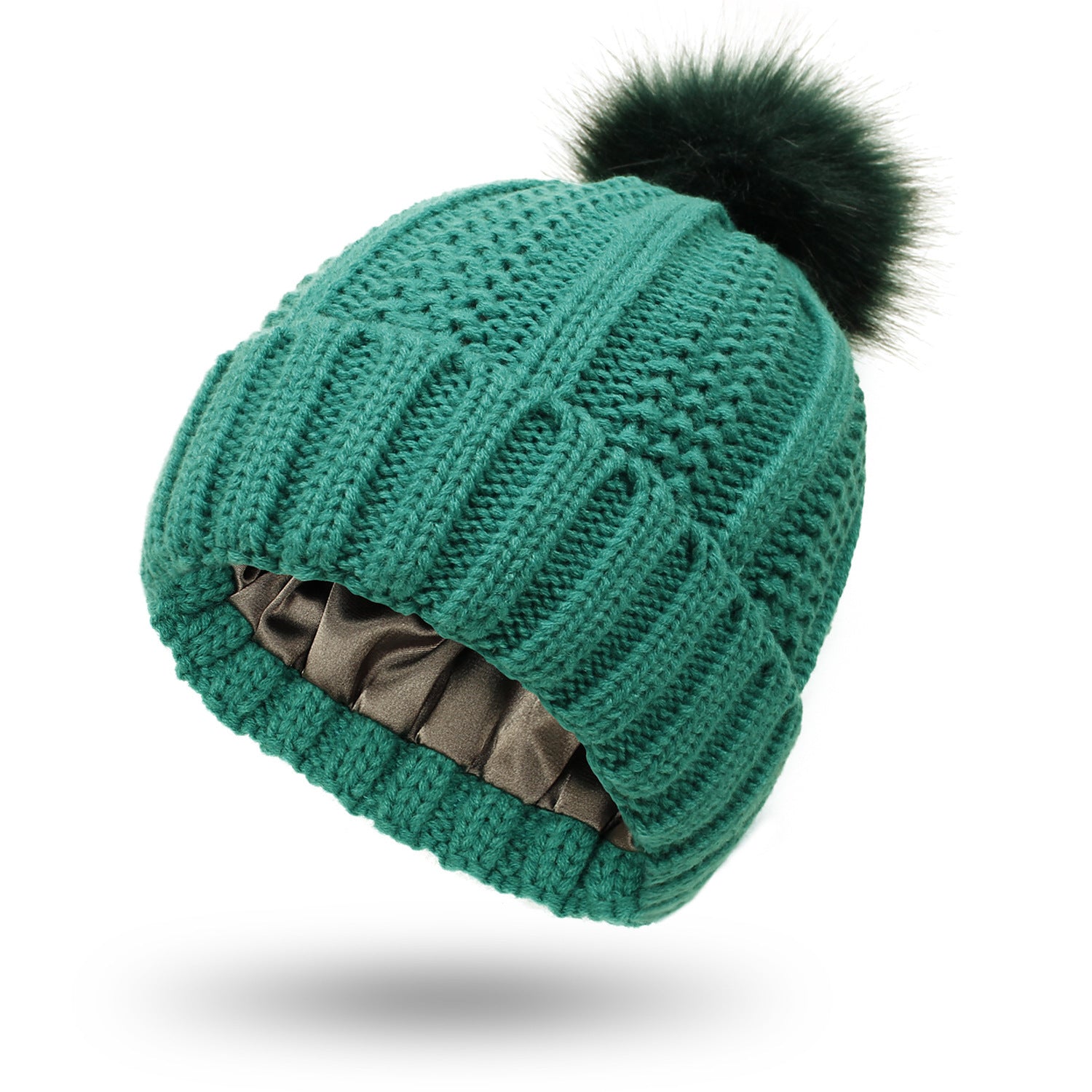 Green knitted beanie with a black pom-pom on a white background