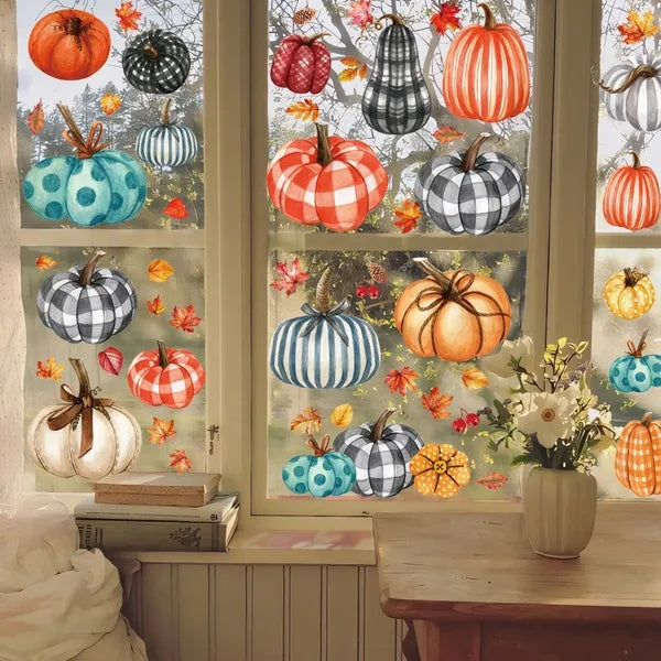 Decorative window with colorful pumpkins and gourds, autumn leaves, and a vase of flowers on a wooden surface.