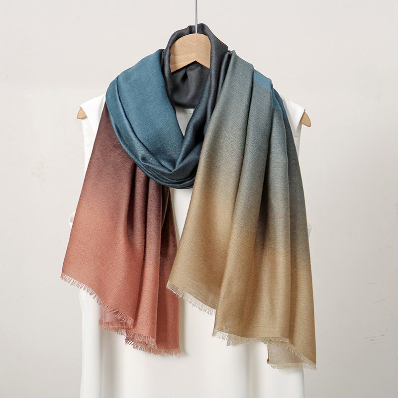 Gradient scarf in blue, green, and brown on a mannequin against a white background