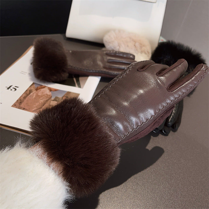 Brown leather gloves with fur cuffs on a gray surface