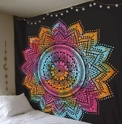 Colorful mandala tapestry hanging on a wall above a bed
