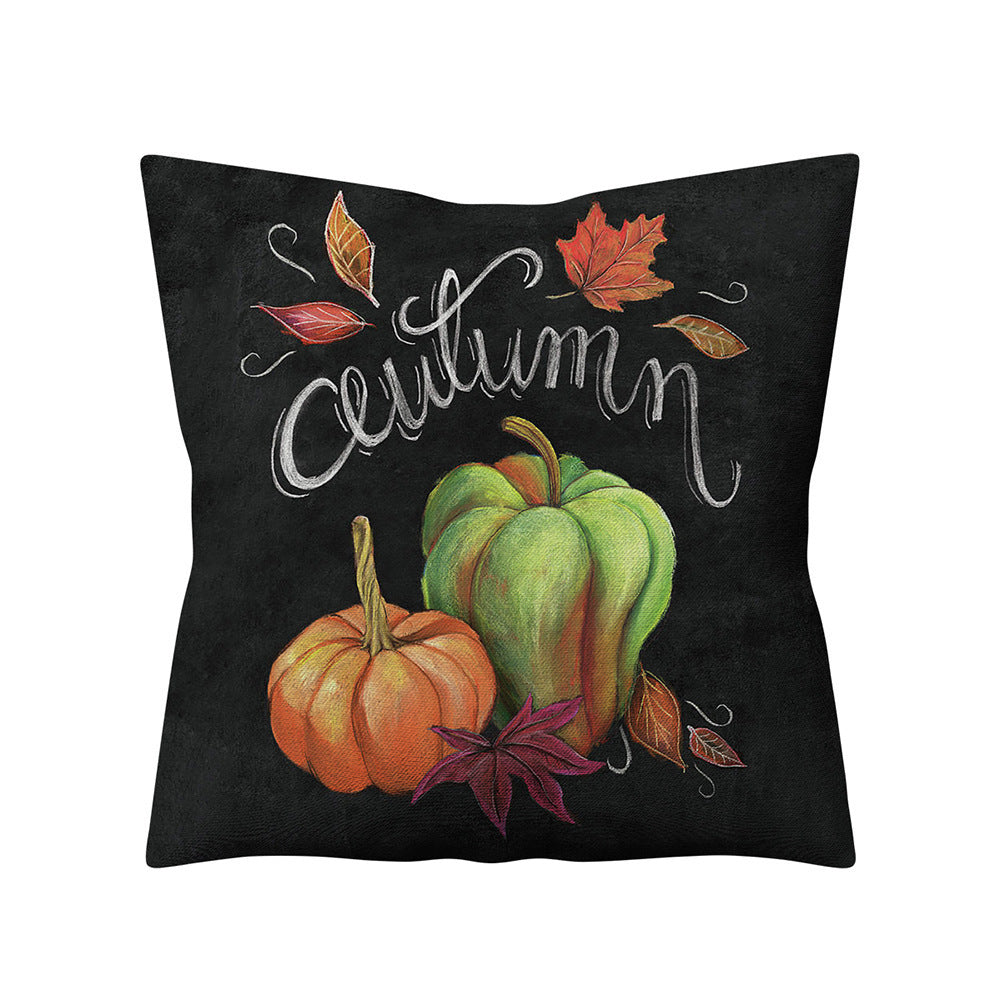 Decorative pillow with pumpkins and leaves on a black background