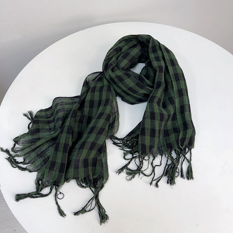 Green plaid scarf on a white surface