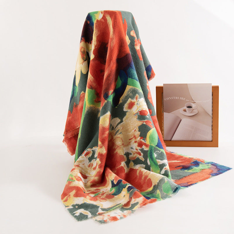 Colorful floral blanket draped over a surface with a book and cup in the background.