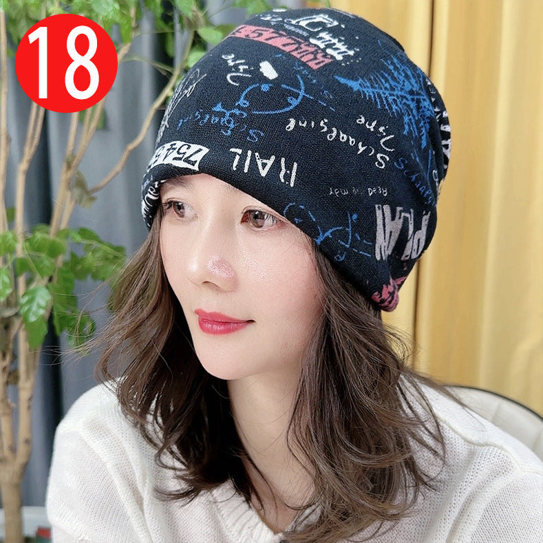 Woman wearing a patterned beanie with a plant and yellow curtain in the background