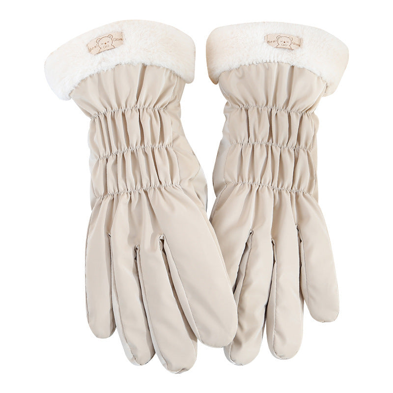 Pair of beige gloves with white fur trim on a white background