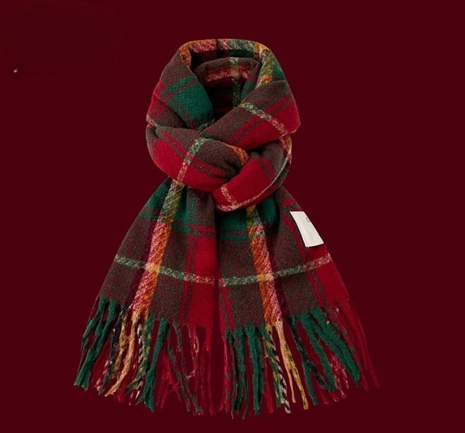 Red and green plaid scarf with fringes on a red background
