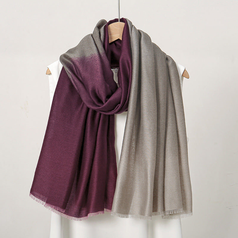 Two scarves, one purple and one gray, draped over a mannequin against a white background.