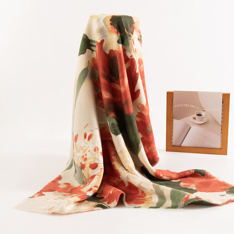 Floral patterned blanket on a white background with a small picture frame.