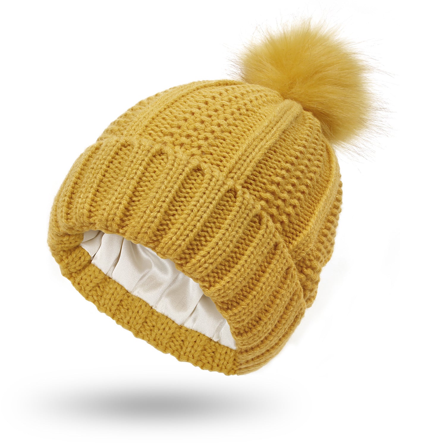 Yellow knitted beanie with a pom-pom on a white background