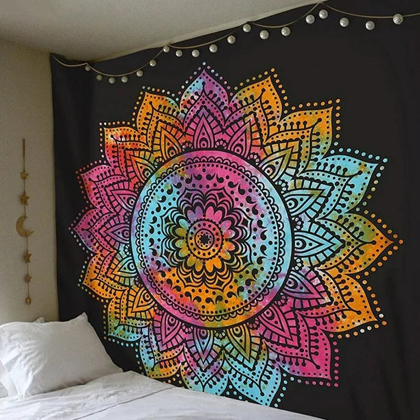 Colorful mandala tapestry hanging on a wall above a bed