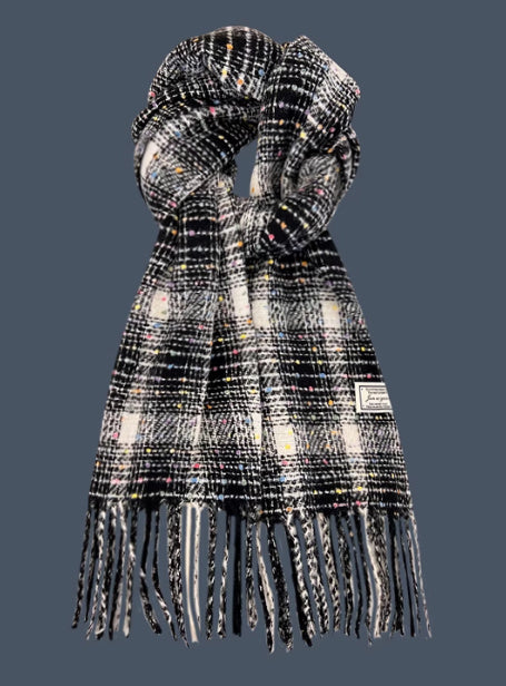 Plaid scarf with fringe details on a dark background