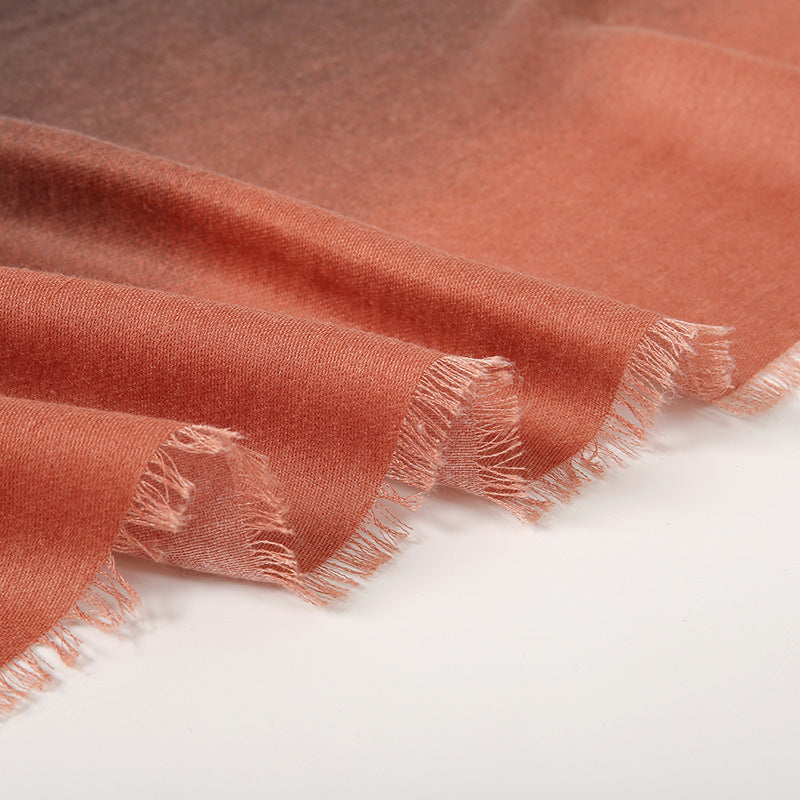 Close-up of a rust-colored fabric with frayed edges on a white background