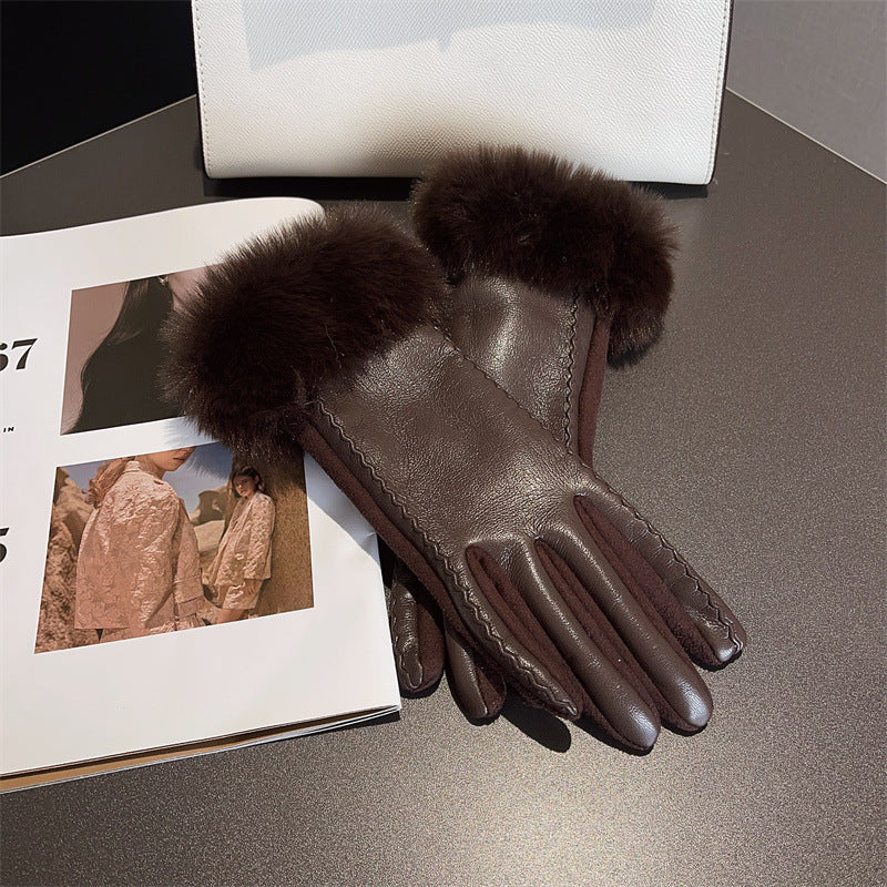 Brown leather gloves with fur cuffs on a gray surface