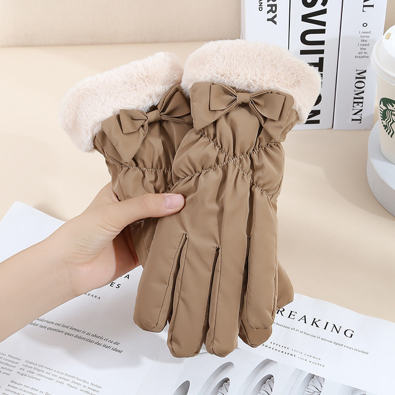 Brown gloves with fur trim held above a newspaper