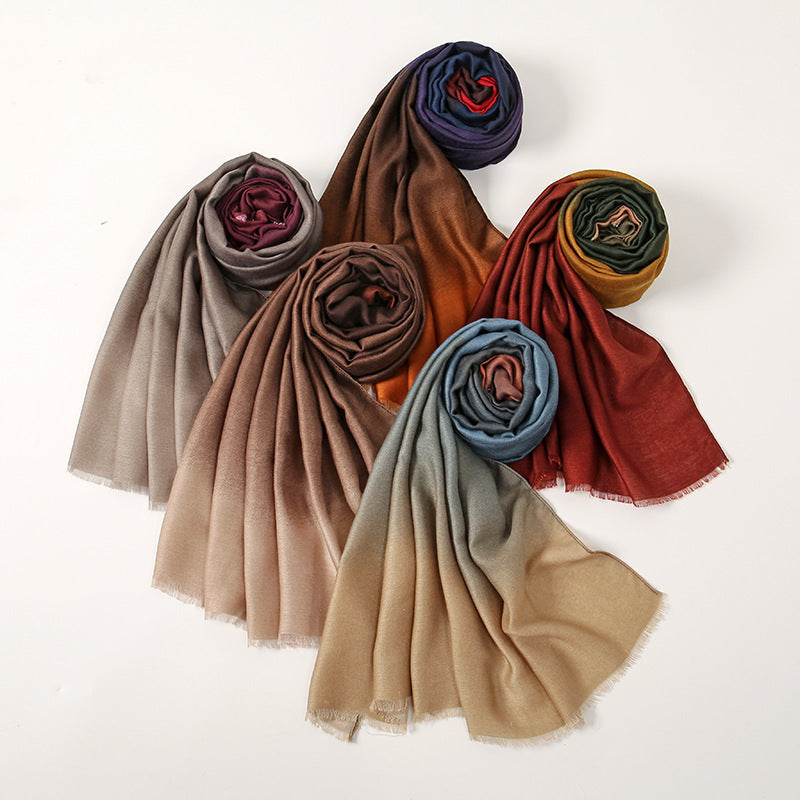 Set of rolled-up scarves in various colors on a white background