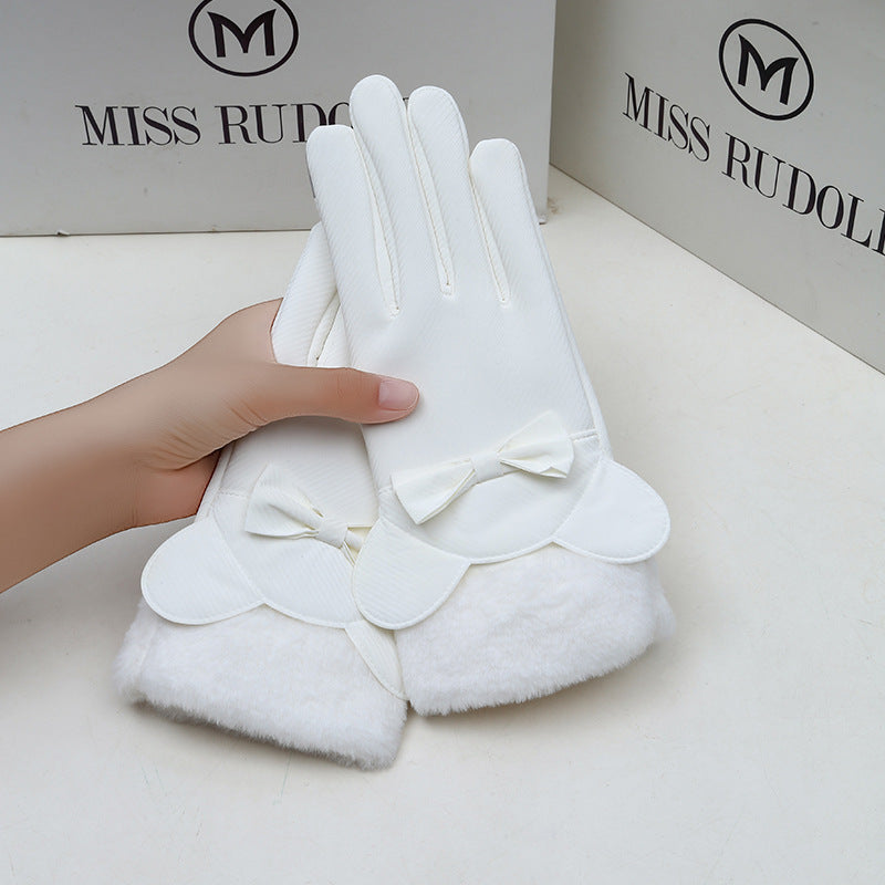 White gloves with bow details held by a hand, with 'MISS RUDOL' branding in the background.
