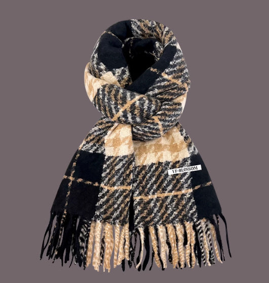 Plaid scarf with fringes on a gray background