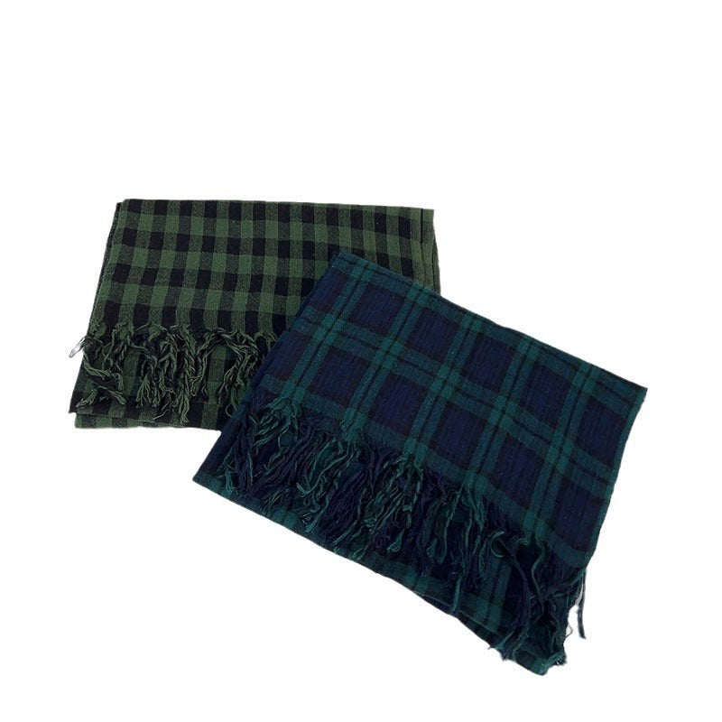 Two plaid scarves with fringes on a white background