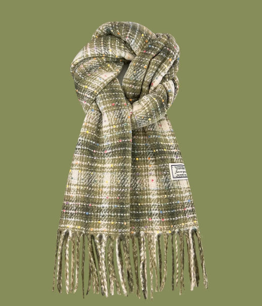 Plaid scarf with fringes on a green background