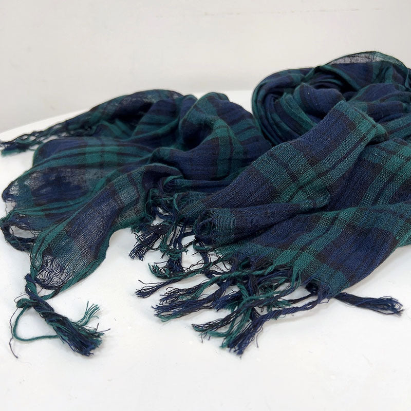 Plaid scarf with tassels on a white background