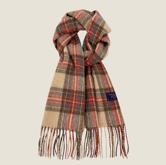 Plaid scarf with fringes on a beige background