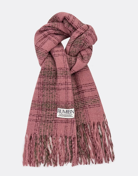 Pink plaid scarf with fringes and a visible brand label on a white background