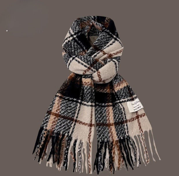 Plaid scarf with fringes on a gray background